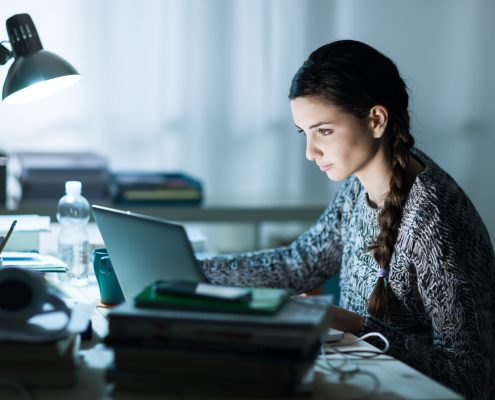 student studying digital sat at night